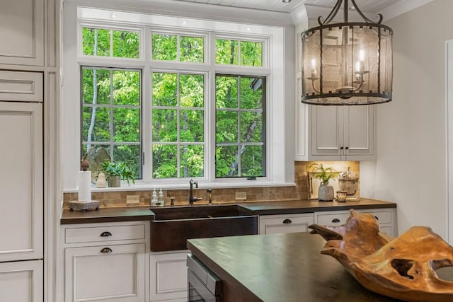 547 Burl Ln, Cashiers, NC 28717 - kitchen with dark countertops, a sink, backsplash, white cabinets, and ornamental molding