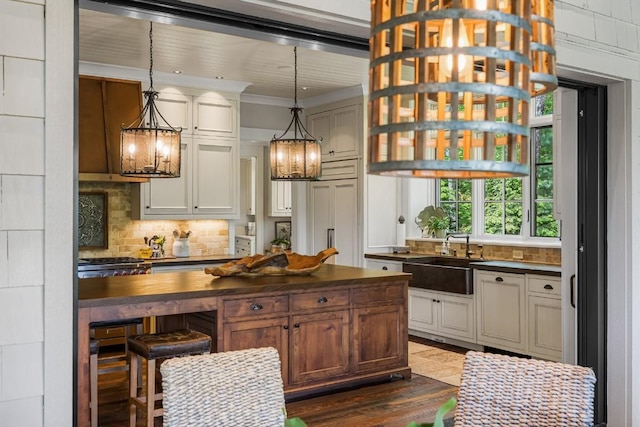547 Burl Ln, Cashiers, NC 28717 - kitchen featuring a sink, butcher block countertops, tasteful backsplash, dark wood finished floors, and ornamental molding