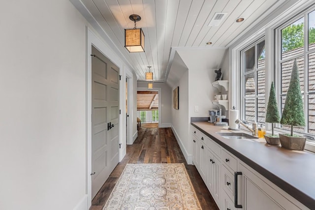 547 Burl Ln, Cashiers, NC 28717 - bar area featuring a sink, dark wood-style floors, hanging light fixtures, and baseboards