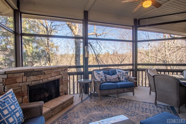 sunroom with a fireplace and ceiling fan