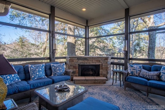 sunroom featuring a fireplace