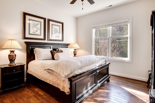 bedroom with ceiling fan and dark wood-type flooring