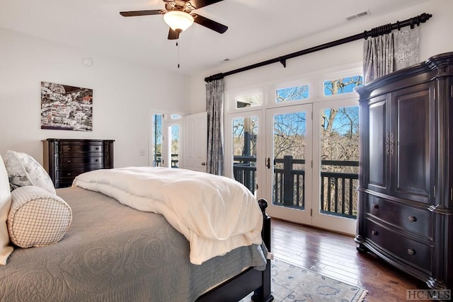 bedroom with ceiling fan, dark wood-type flooring, and access to outside