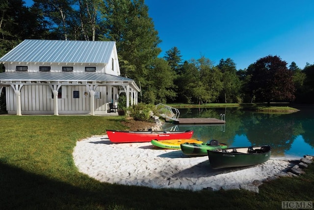 view of home's community featuring a water view and a lawn