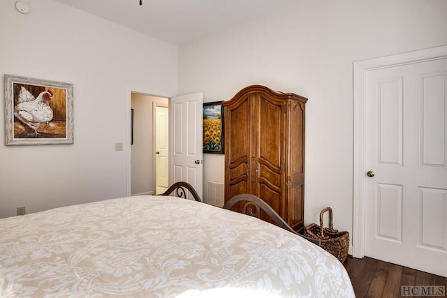 bedroom with dark hardwood / wood-style floors