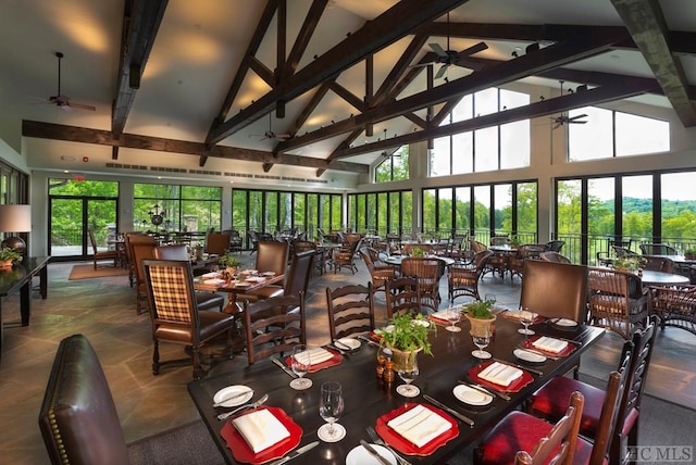 dining space with high vaulted ceiling, beamed ceiling, and ceiling fan