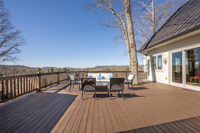 deck featuring a mountain view and outdoor lounge area