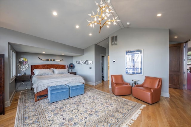 bedroom featuring visible vents, light wood-style flooring, baseboards, a chandelier, and vaulted ceiling