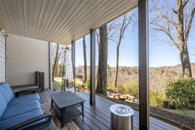 wooden deck featuring a view of trees