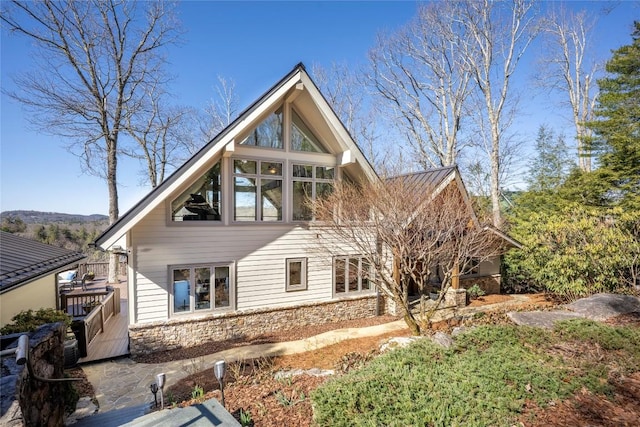 rear view of house with stone siding