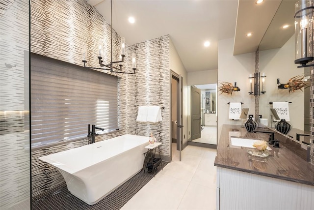 bathroom with vanity, tile patterned floors, a freestanding tub, and recessed lighting