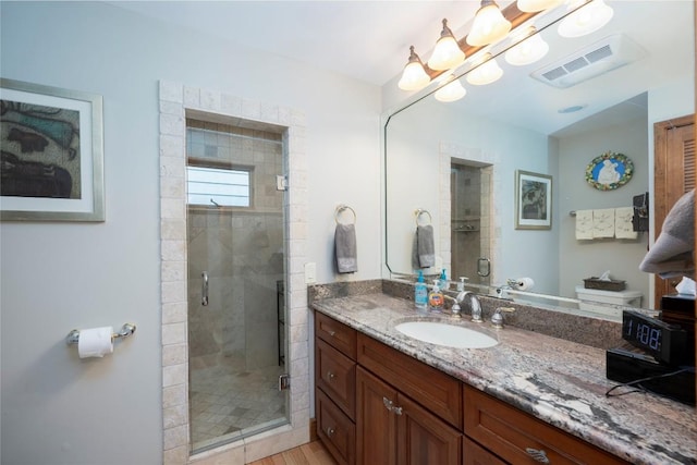 full bath featuring visible vents, a shower stall, and vanity