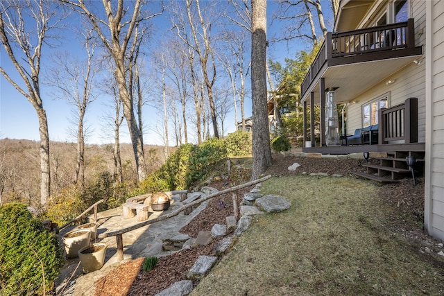 view of yard with a balcony and a fire pit