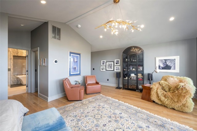 living room with lofted ceiling, wood finished floors, visible vents, and a chandelier