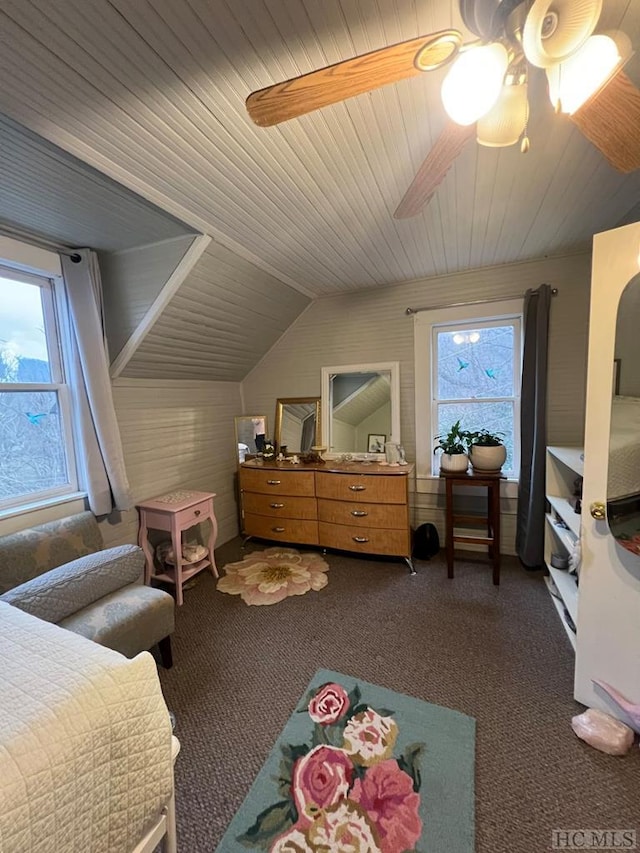 bedroom with lofted ceiling, ceiling fan, and dark colored carpet