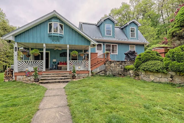 view of front of property with metal roof, a porch, and a front yard