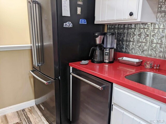 369 Meadow Way Unit 1713, Sapphire, NC 28774 - kitchen with dishwasher, white cabinetry, wood finished floors, and tasteful backsplash