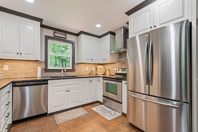 229 Yellow Bird Branch Rd, Sylva, NC 28779 - kitchen featuring stainless steel appliances, wall chimney range hood, white cabinets, decorative backsplash, and recessed lighting