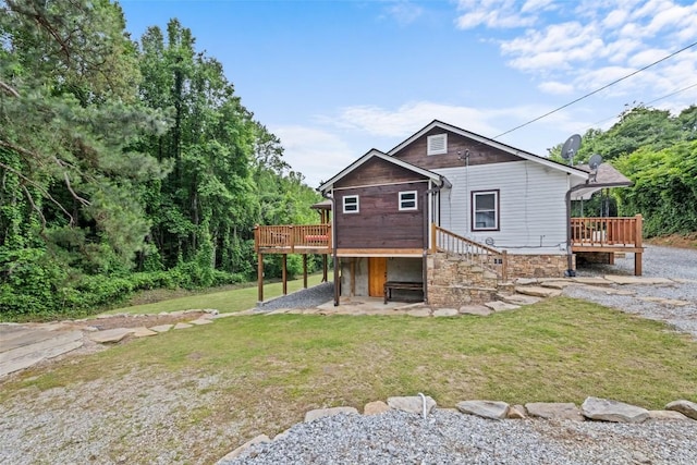 229 Yellow Bird Branch Rd, Sylva, NC 28779 - back of house featuring a wooden deck, a lawn, a patio, and stone siding