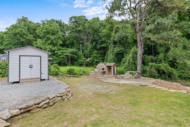229 Yellow Bird Branch Rd, Sylva, NC 28779 - view of grassy yard with a storage shed, a patio area, and a wooded view