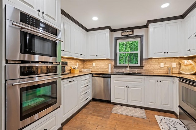 229 Yellow Bird Branch Rd, Sylva, NC 28779 - kitchen with appliances with stainless steel finishes, white cabinetry, light wood-type flooring, tasteful backsplash, and recessed lighting