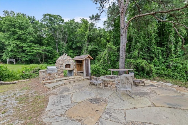 229 Yellow Bird Branch Rd, Sylva, NC 28779 - view of patio / terrace featuring an outdoor fire pit, area for grilling, and a wooded view