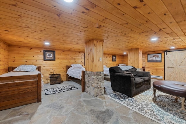 229 Yellow Bird Branch Rd, Sylva, NC 28779 - bedroom featuring wooden ceiling, wooden walls, a barn door, stone finish floors, and recessed lighting