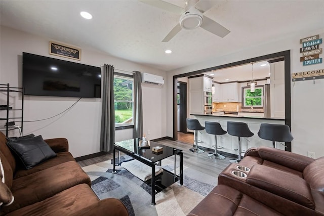 229 Yellow Bird Branch Rd, Sylva, NC 28779 - living area with light wood-style flooring, an AC wall unit, healthy amount of natural light, and recessed lighting