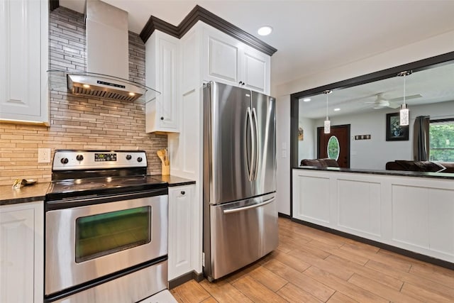 229 Yellow Bird Branch Rd, Sylva, NC 28779 - kitchen featuring appliances with stainless steel finishes, wall chimney exhaust hood, dark countertops, backsplash, and white cabinets