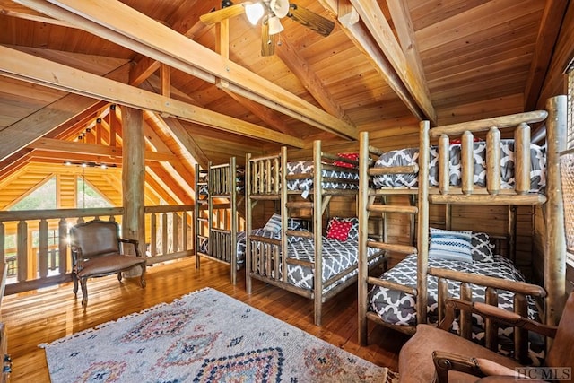 bedroom with vaulted ceiling with beams, wood-type flooring, and wooden ceiling