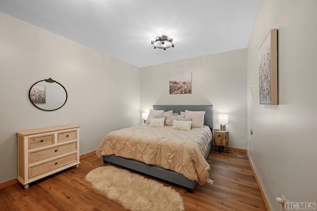 bedroom with hardwood / wood-style floors