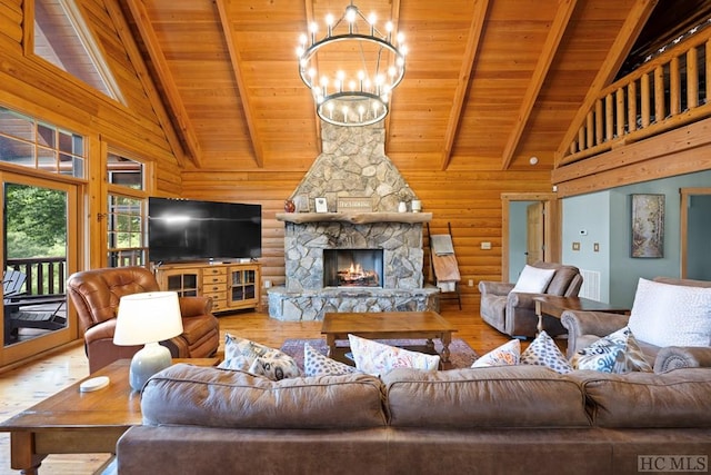 living room with wood-type flooring, a stone fireplace, wooden ceiling, and a chandelier