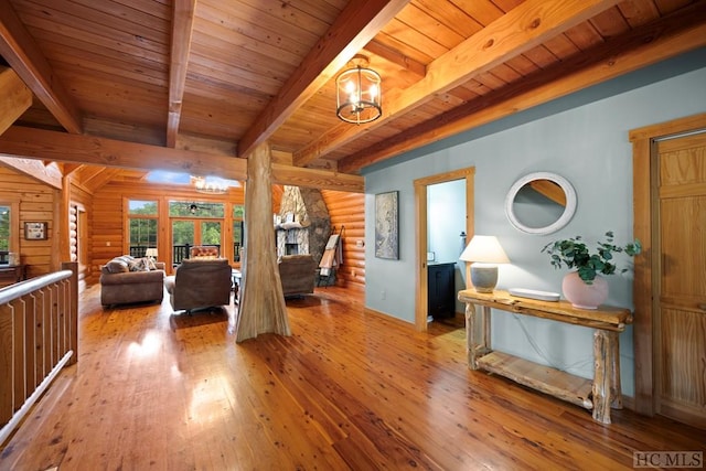 bedroom with beam ceiling, log walls, and light wood-type flooring