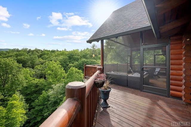 wooden deck featuring a sunroom and an outdoor hangout area