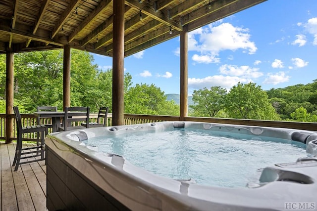 wooden deck with a hot tub