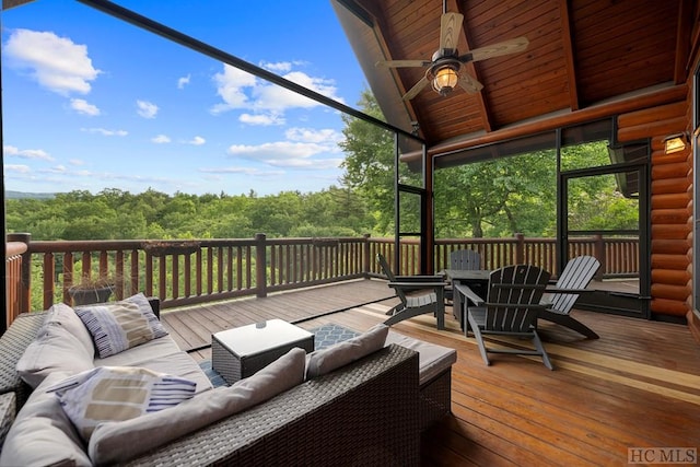 sunroom featuring ceiling fan and lofted ceiling