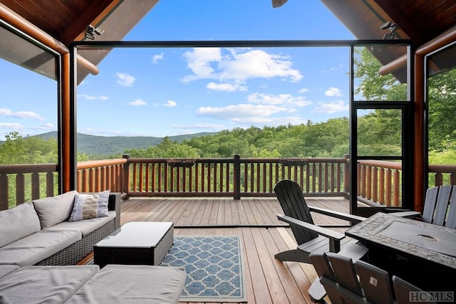 wooden deck with an outdoor living space