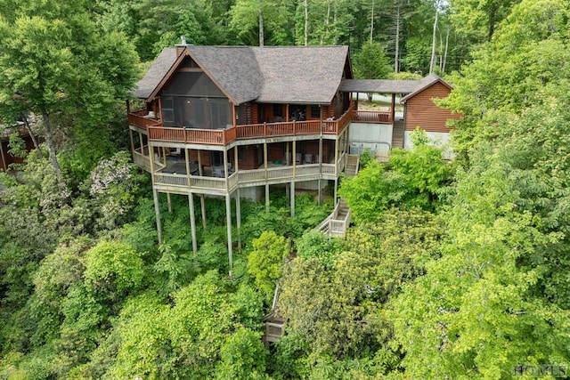 back of property featuring a wooden deck