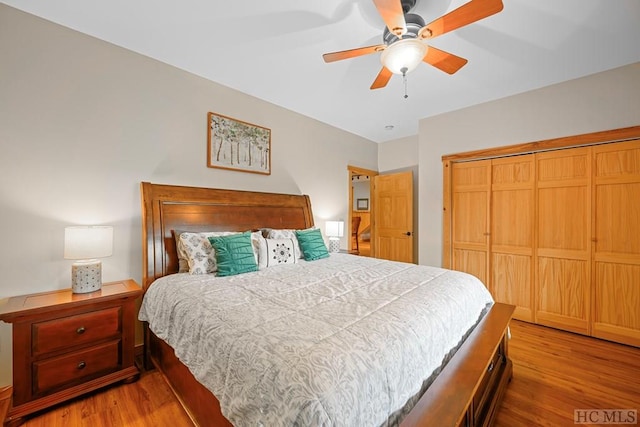 bedroom featuring ceiling fan, light hardwood / wood-style floors, and a closet