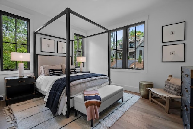 bedroom featuring baseboards and wood finished floors