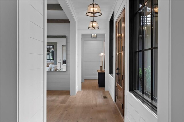 corridor with visible vents and light wood-type flooring