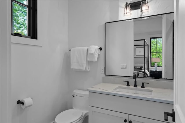 half bathroom with vanity and toilet
