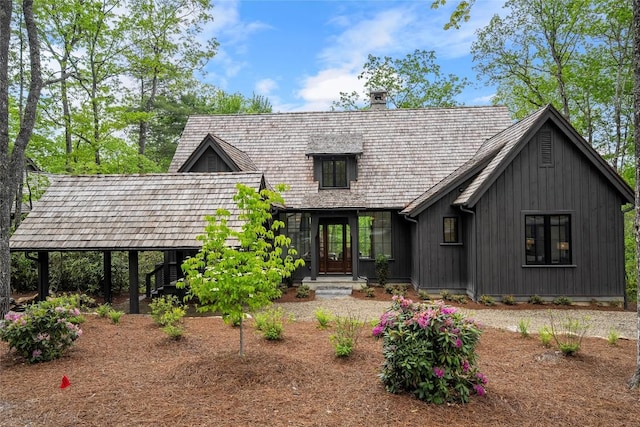 view of front of house featuring board and batten siding and a chimney