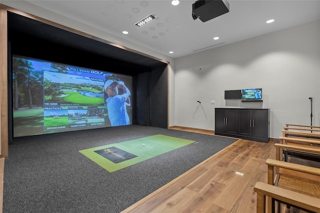 recreation room featuring recessed lighting, wood finished floors, and golf simulator