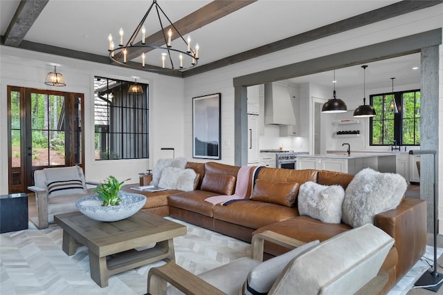 living room featuring an inviting chandelier and beam ceiling