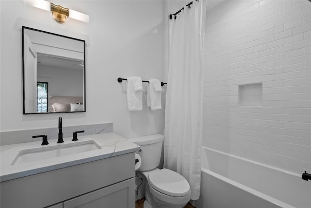 bathroom featuring vanity, shower / bath combination with curtain, and toilet