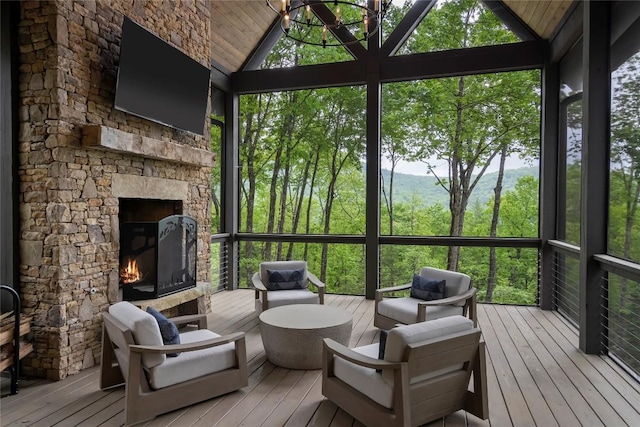 sunroom featuring an outdoor living space with a fireplace