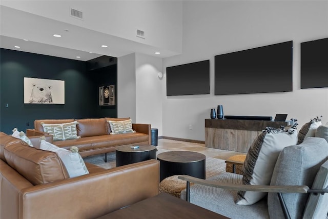 living room with baseboards, recessed lighting, and visible vents