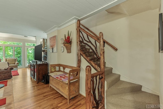 staircase featuring ornate columns and wood-type flooring