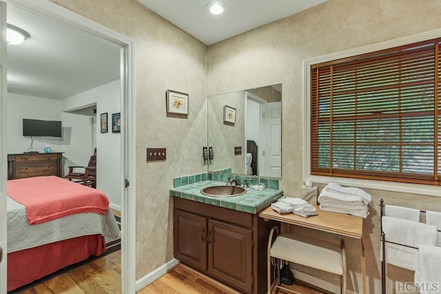 bathroom with hardwood / wood-style flooring and vanity